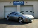 Silver sports car parked in front of a building with garage doors