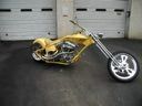 Yellow custom chopper motorcycle parked on a gray floor