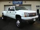 White pickup truck parked outside a dealership showroom