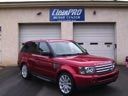 Red SUV parked in front of a garage with a Liberty Pro sign