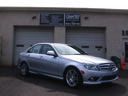 Silver sedan parked in front of a garage with closed doors