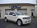 White SUV parked in front of a beige building with garage doors
