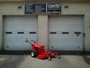 Red fire truck parked in front of a building with two closed garage doors