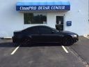 Black car parked in front of a BluePRO Detail Center building