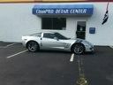 White sports car parked outside a Chase's Dream Center building with a large sign above the door.