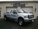 Silver pickup truck parked indoors at a car dealership showroom
