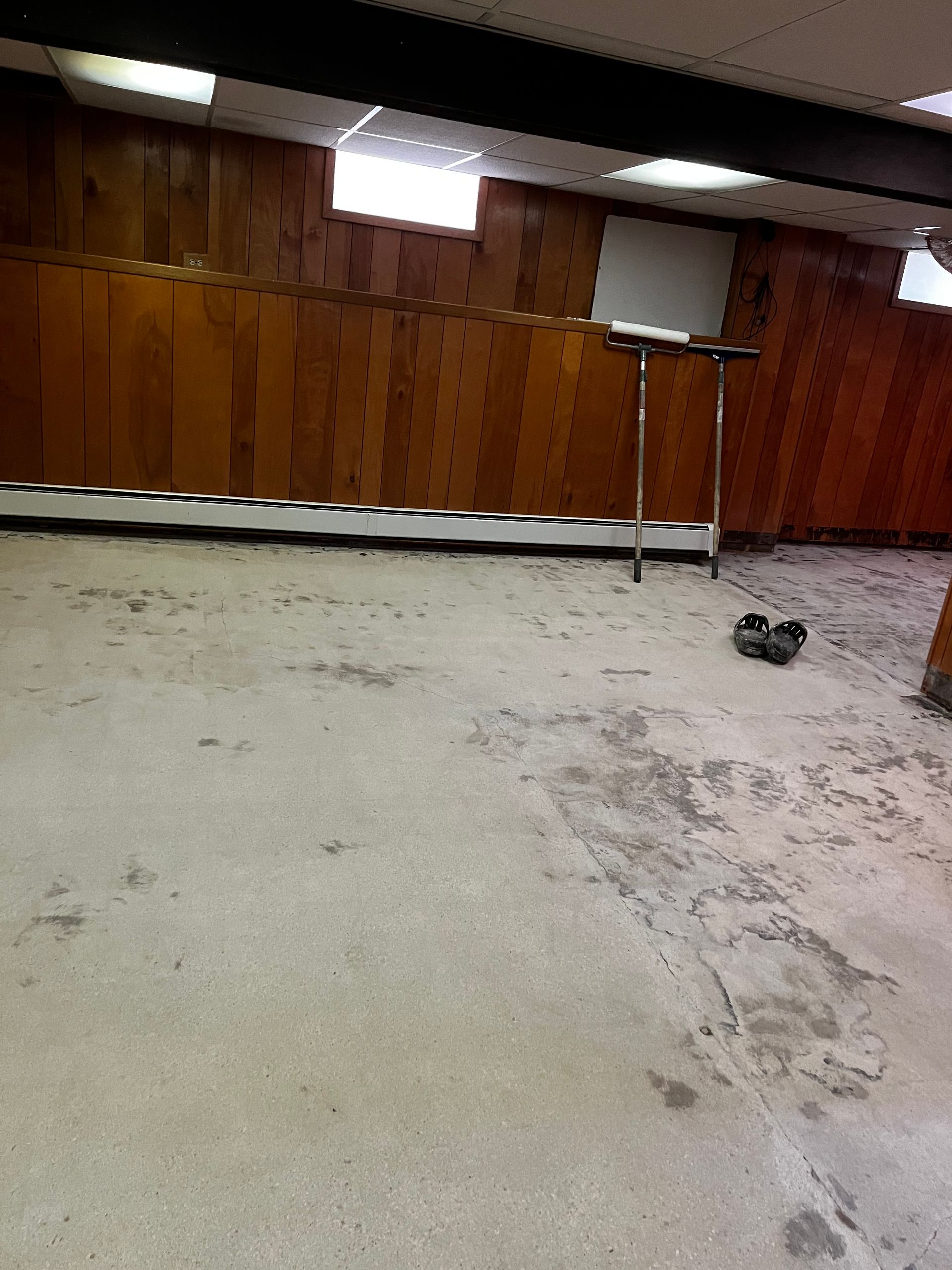 An empty room with wooden walls and a white floor