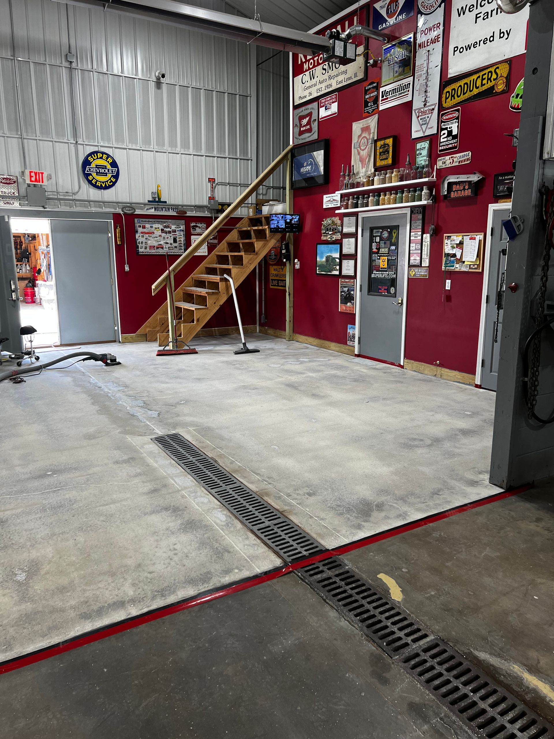 A garage with a staircase leading up to the second floor