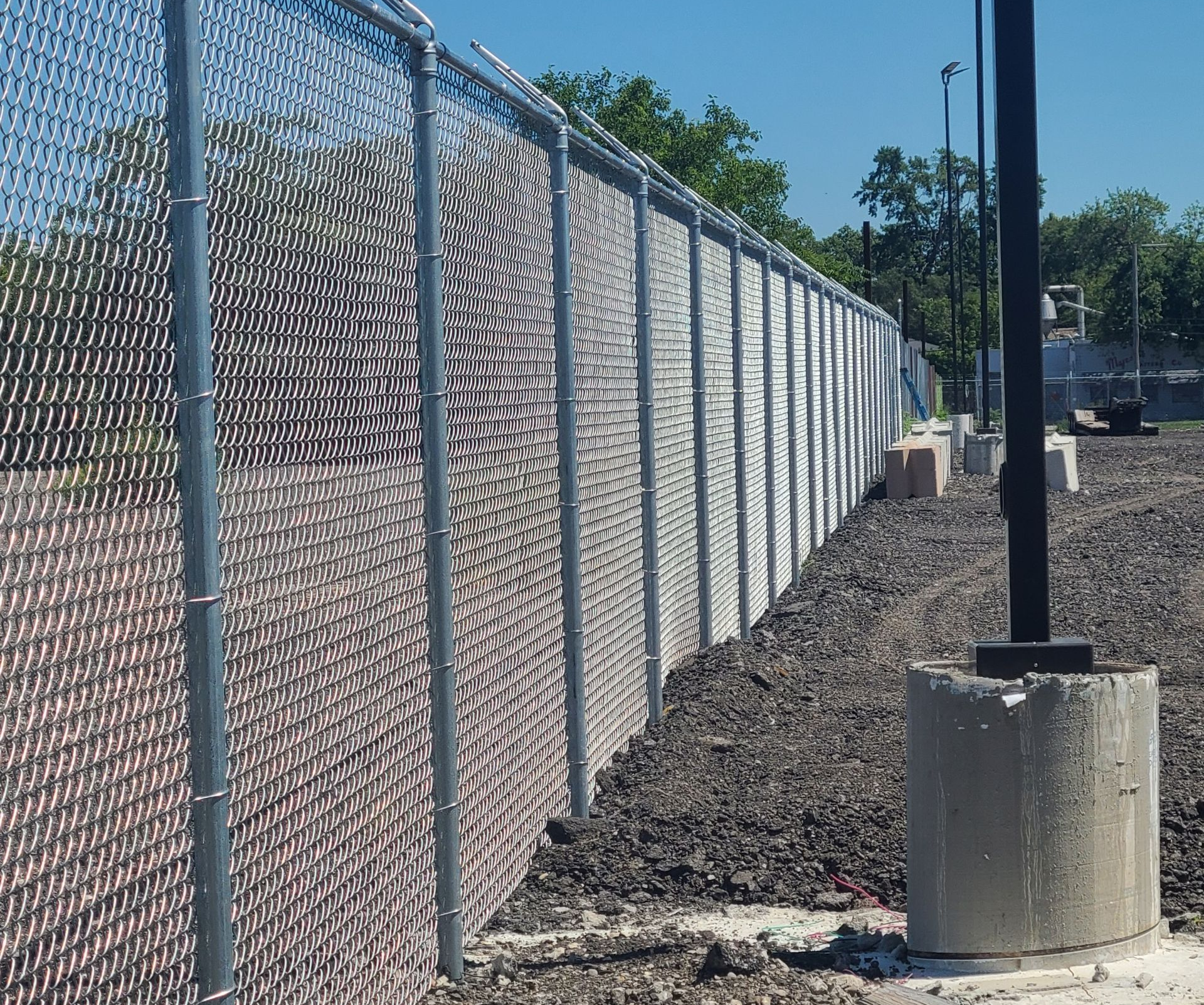 Commercial chain-link fence installation for long-term property security and low maintenance