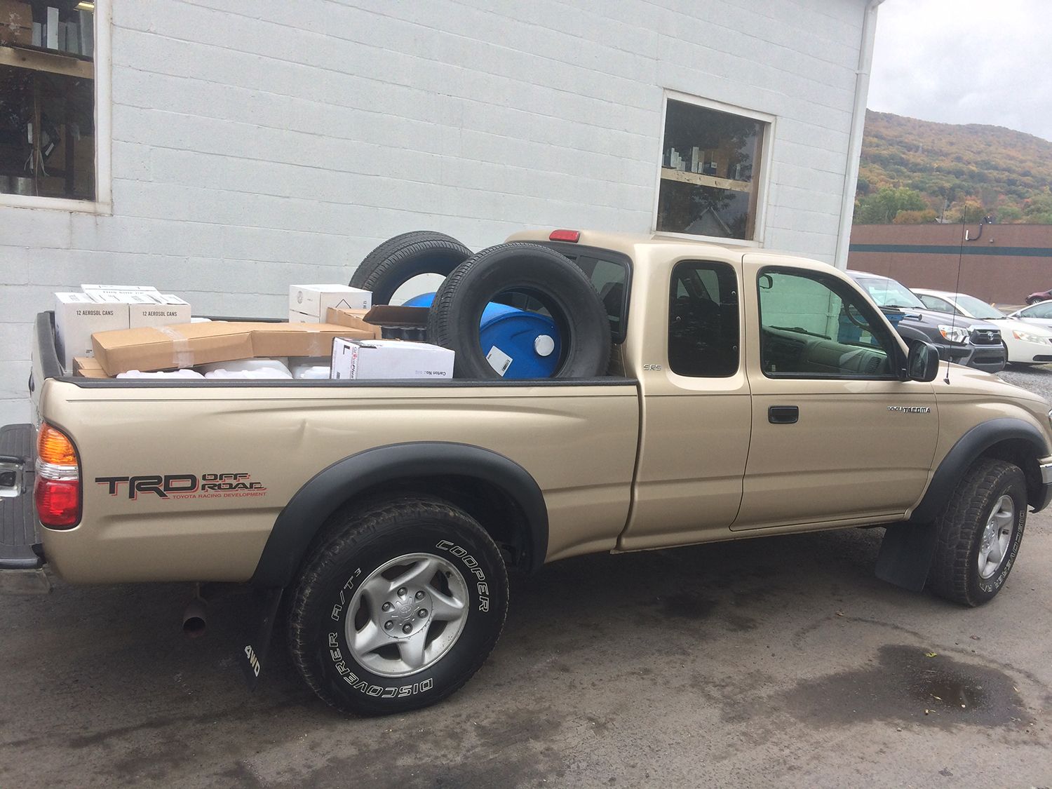 A toyota tacoma truck is parked in front of a building.