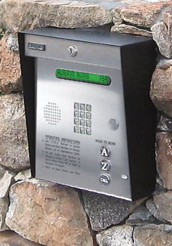 A keypad on a stone wall that says alert zone
