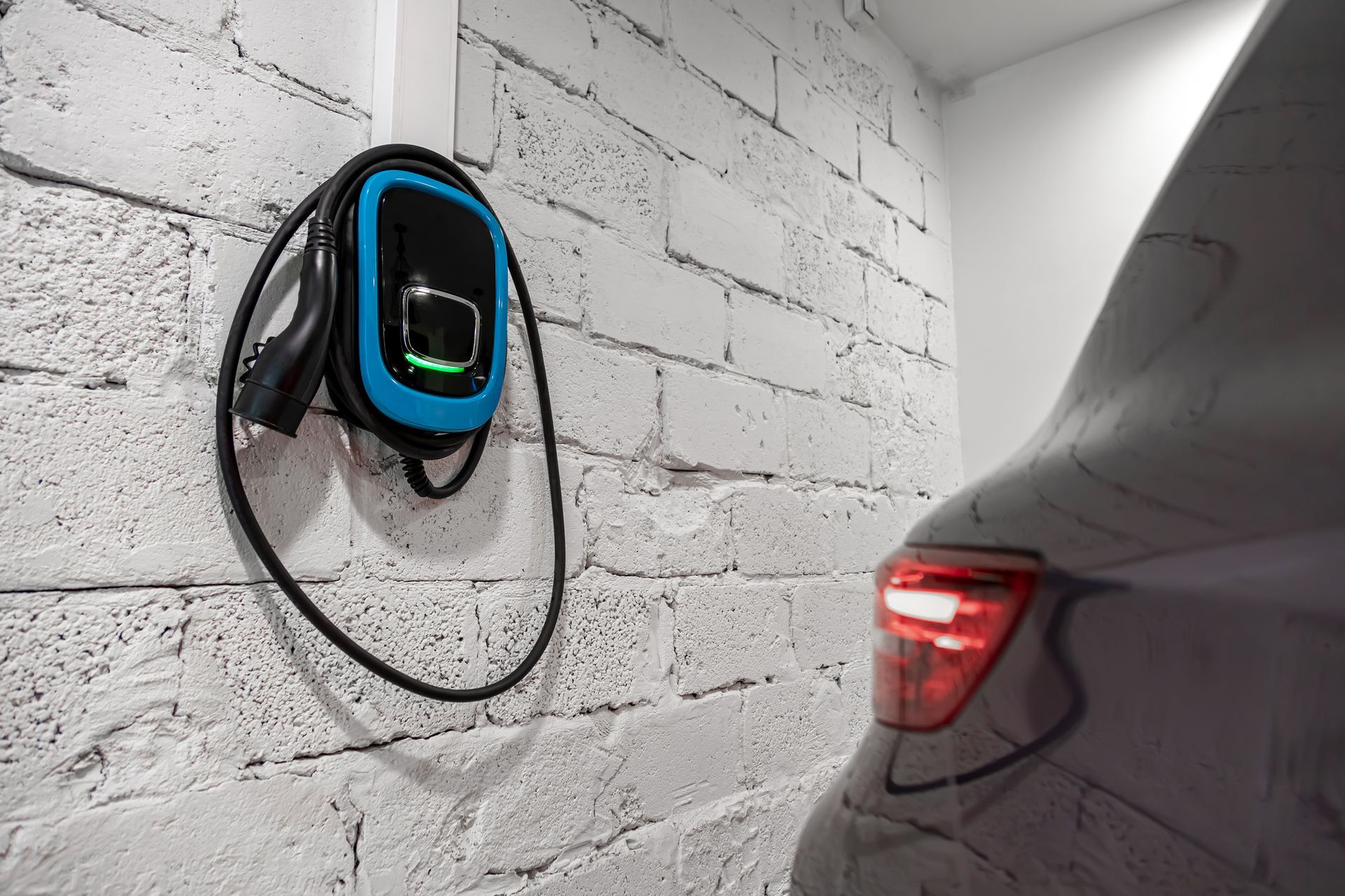 An electric car is being charged in a garage.