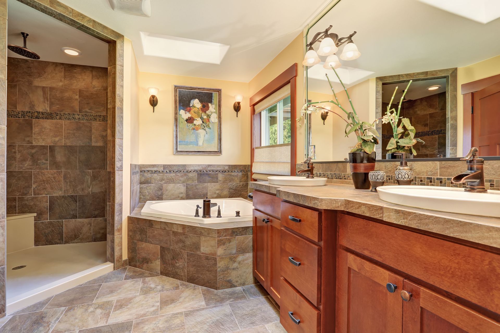 Elegant bathroom with double vanity, large mirror, and tiled soaking tub with shower.