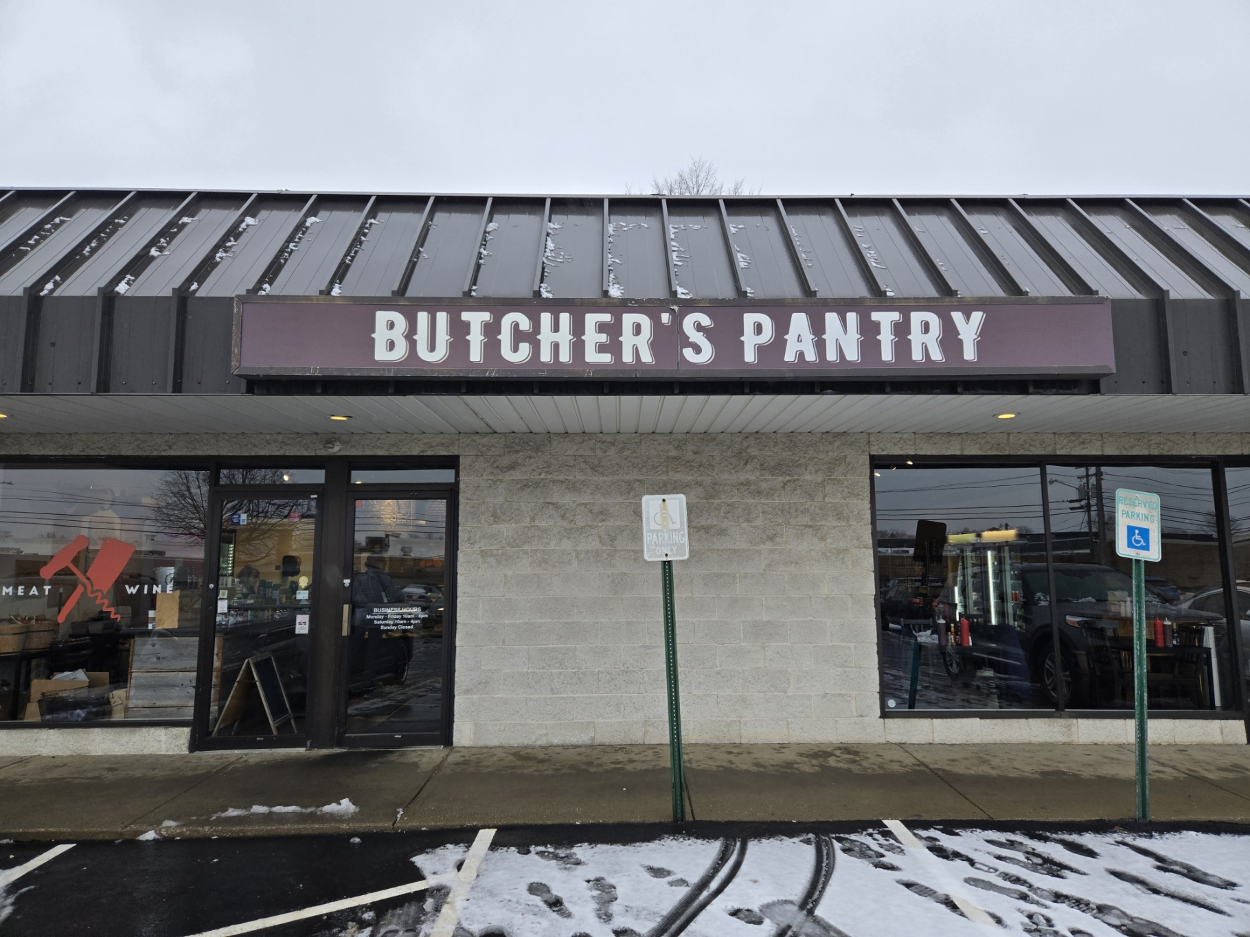A butcher 's pantry is located in a parking lot