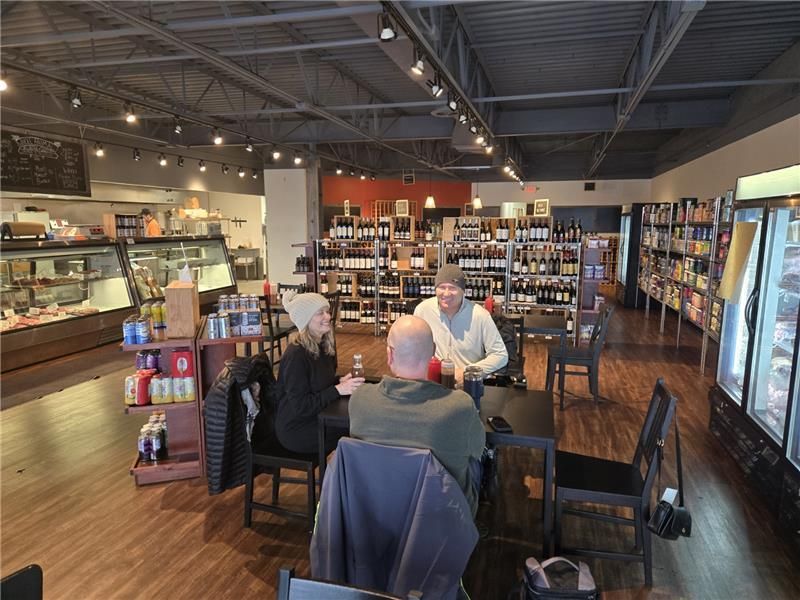 A group of people are sitting at tables in a store.