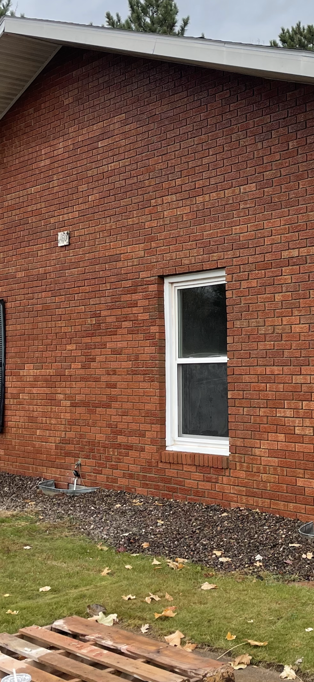 A red brick building with a white window