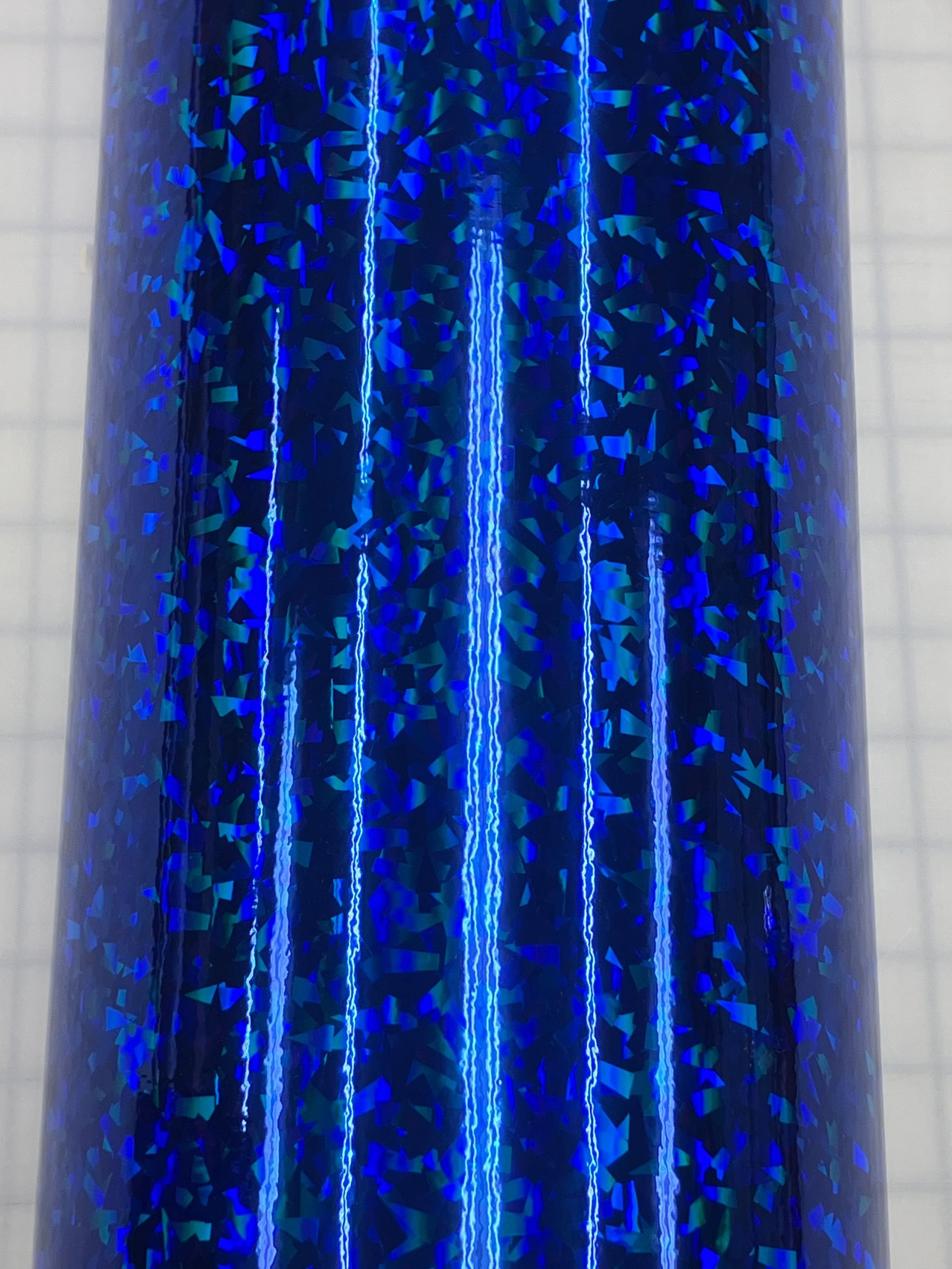 Blue glittery fabric with vertical silver stripes and shimmering specks.