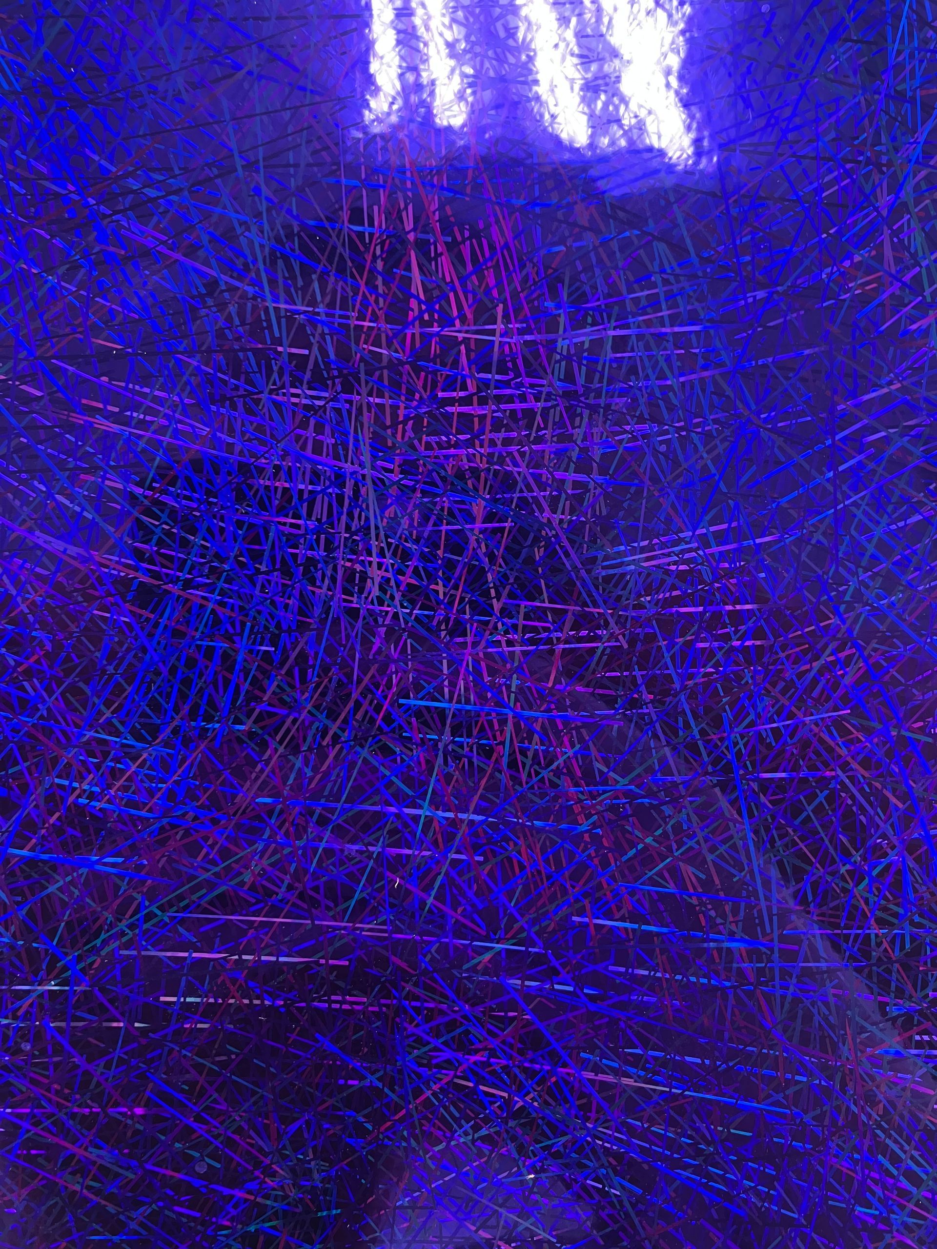 Abstract purple and blue neon light streaks over a dark background