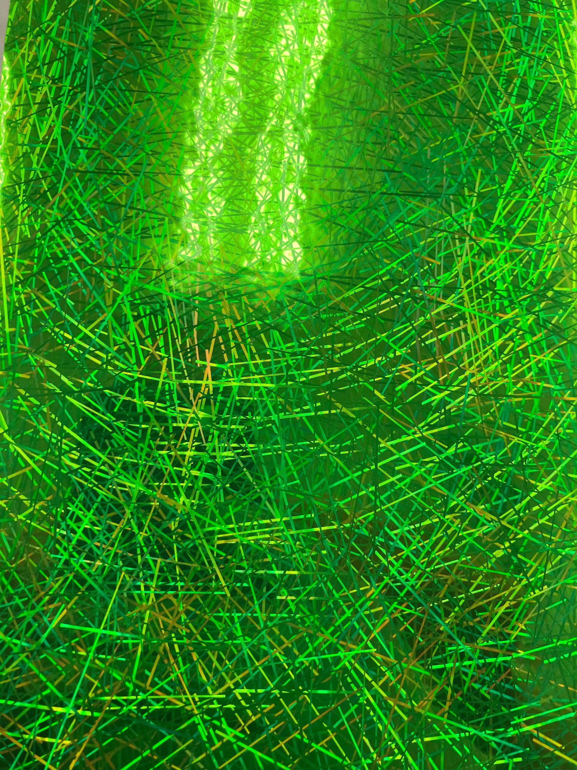 Abstract green textured pattern with overlapping bright lines and a glowing vertical center area