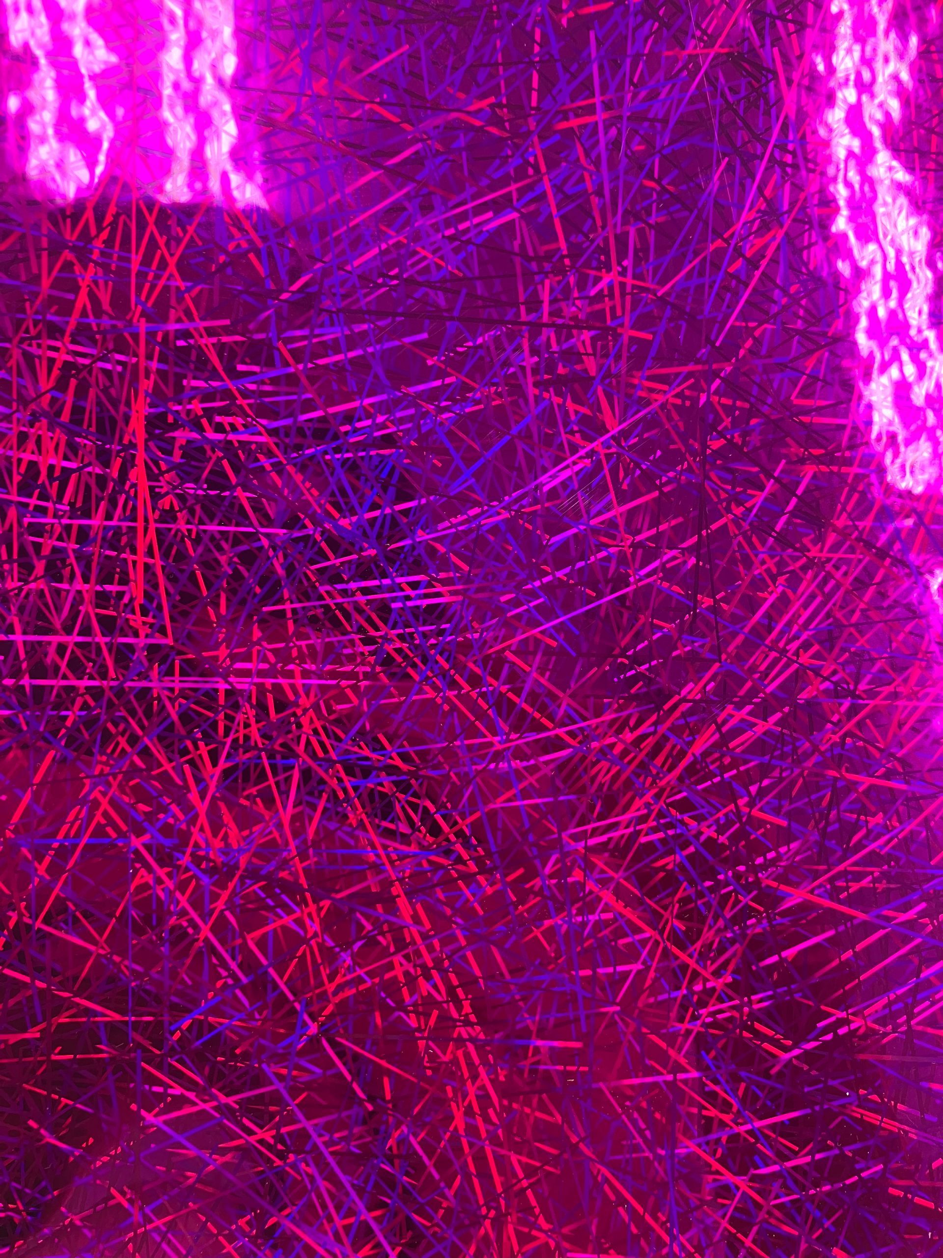 Abstract magenta and purple light streaks forming a dense textured pattern