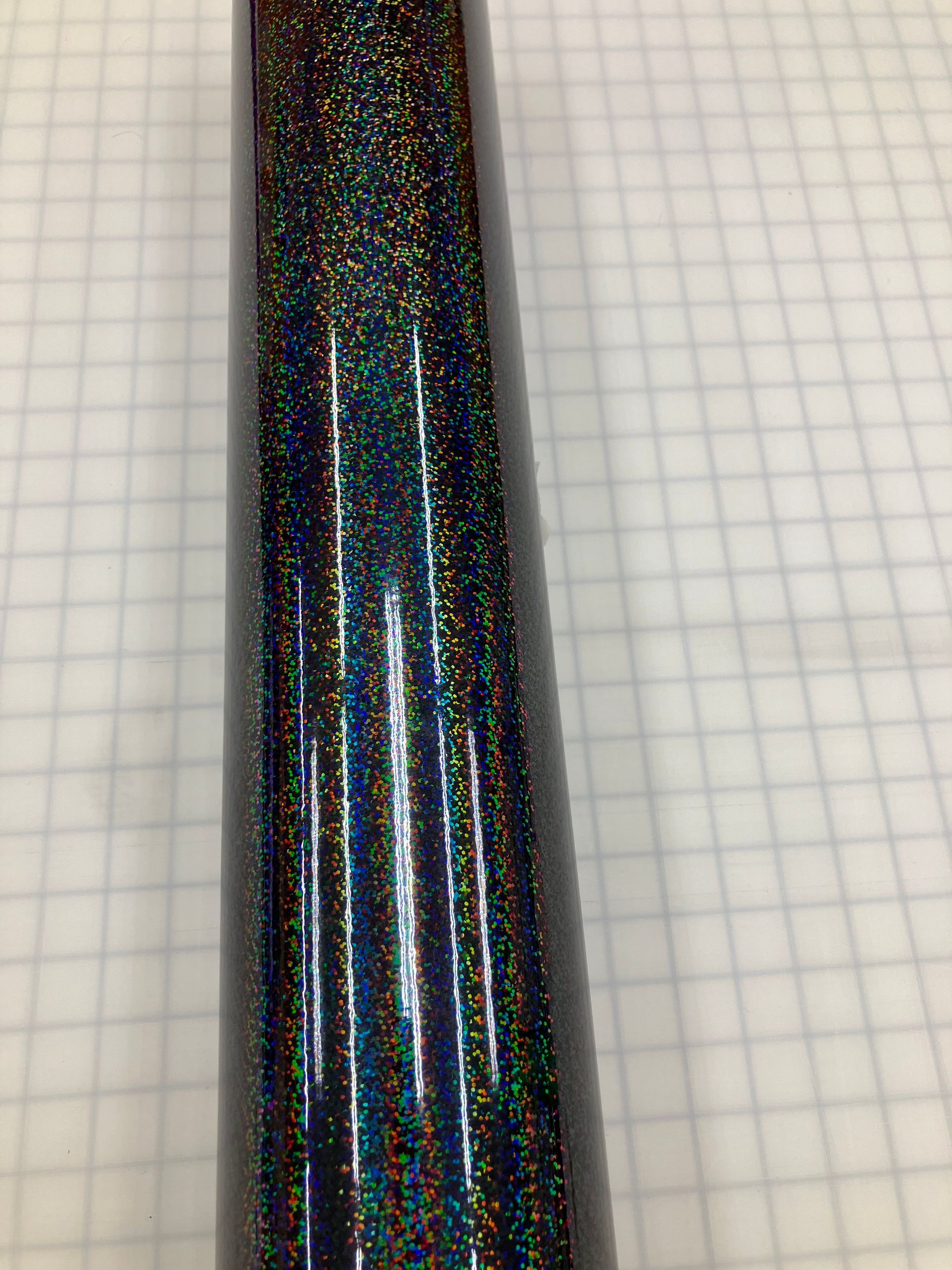 Close-up of a black holographic pen on graph paper