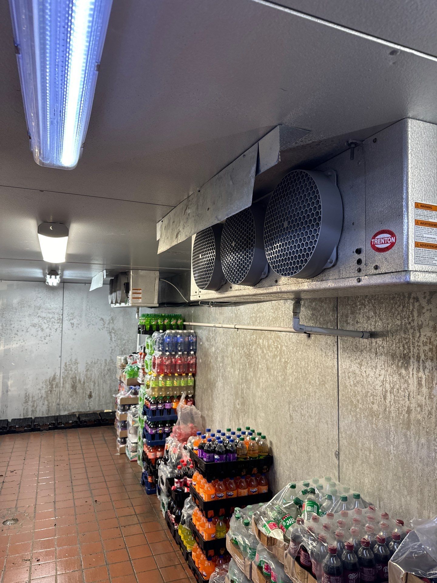 A refrigerator filled with lots of bottles of soda.