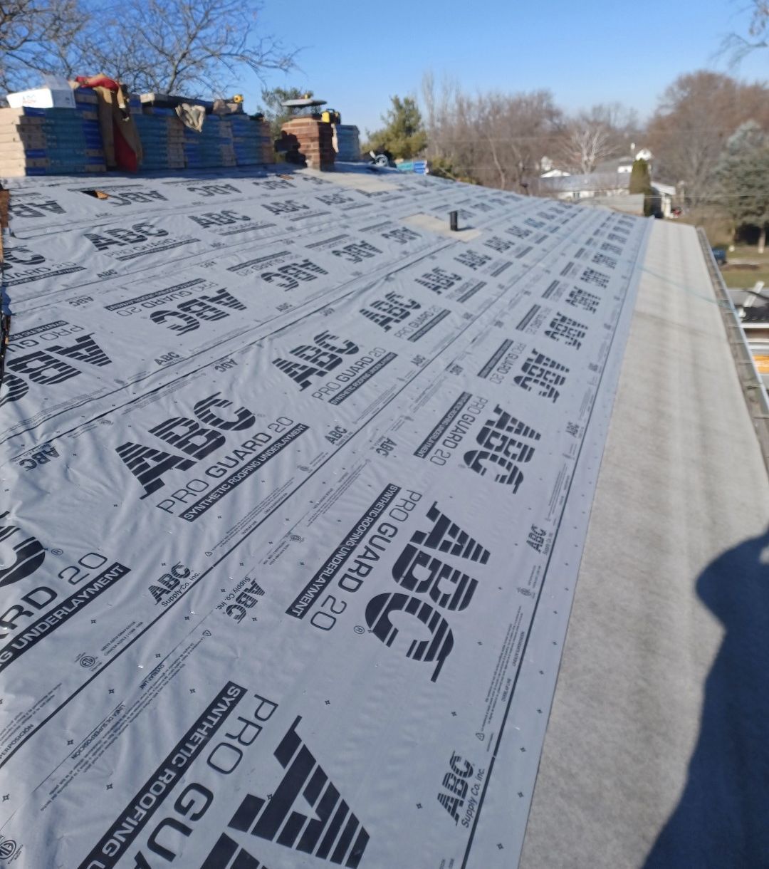 Roof partially covered with black underlayment labeled 