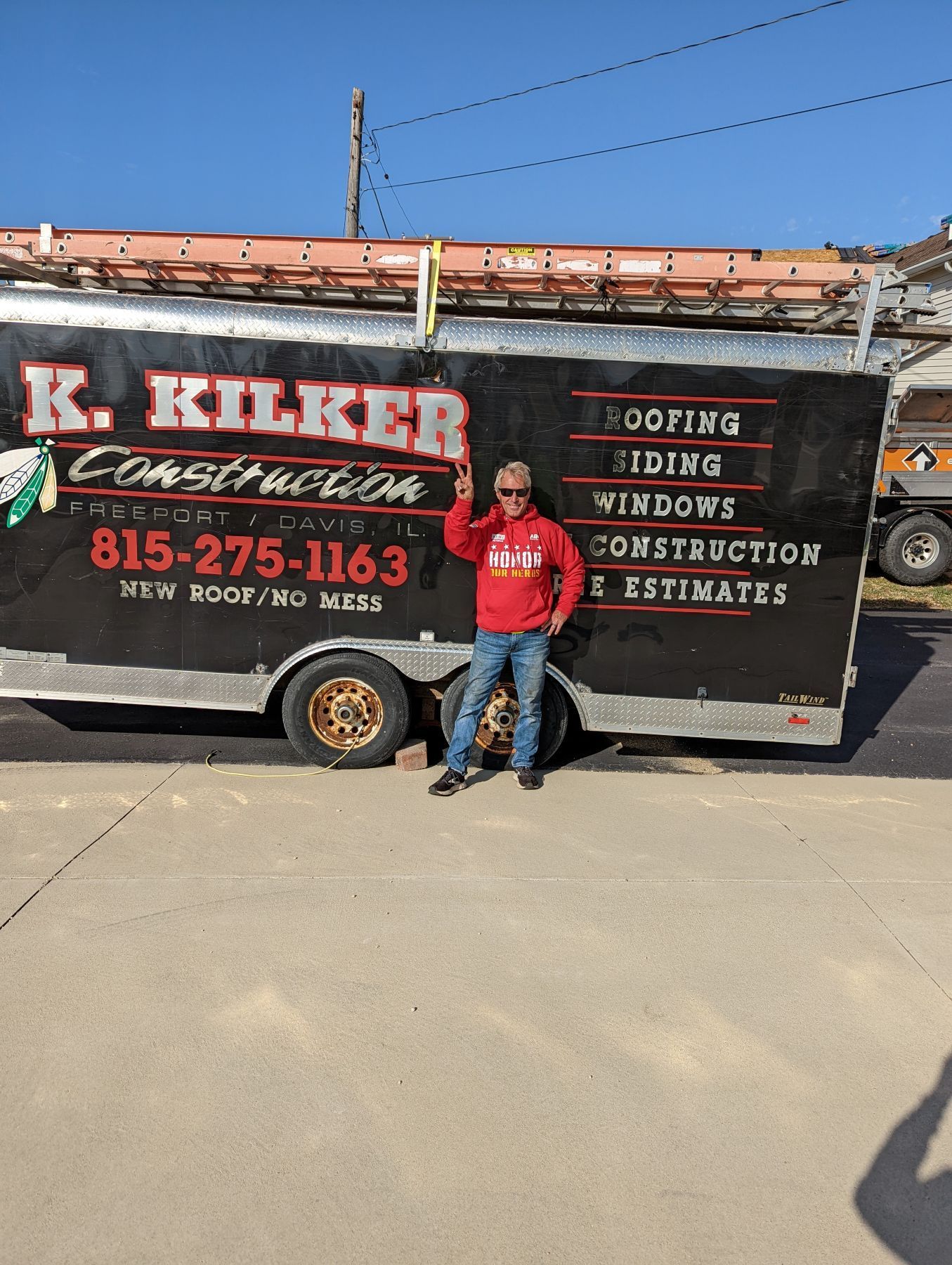 Man standing beside a trailer with 