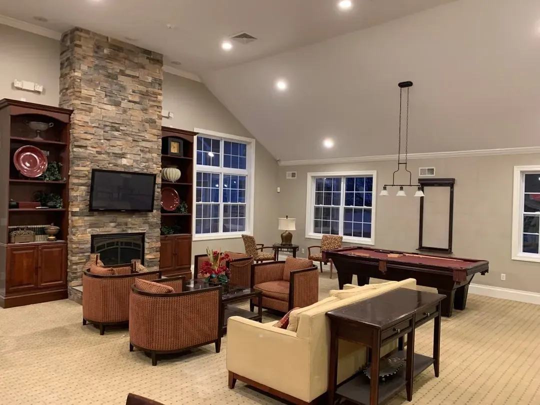 Empty room with black and white striped accent wall, white doors, and beige carpet.