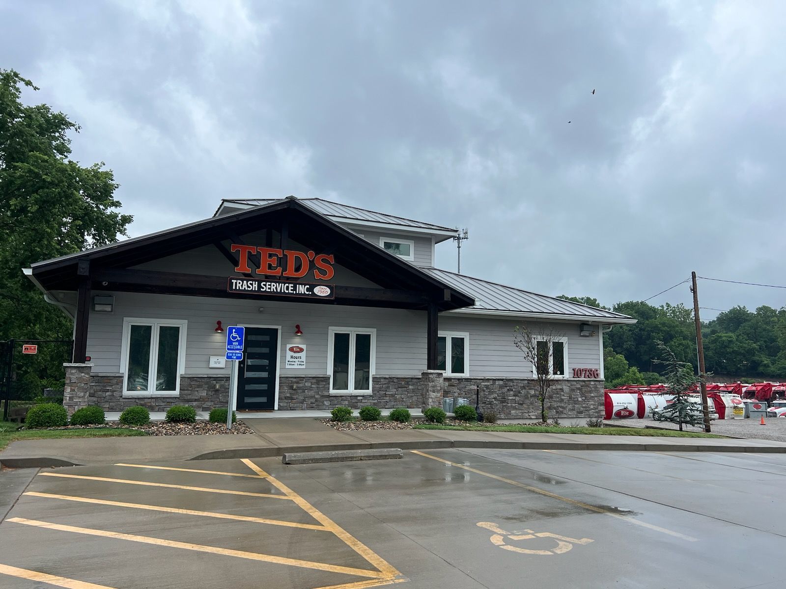 TEDS restaurant building with dark roof, white walls, and wet parking lot under cloudy sky