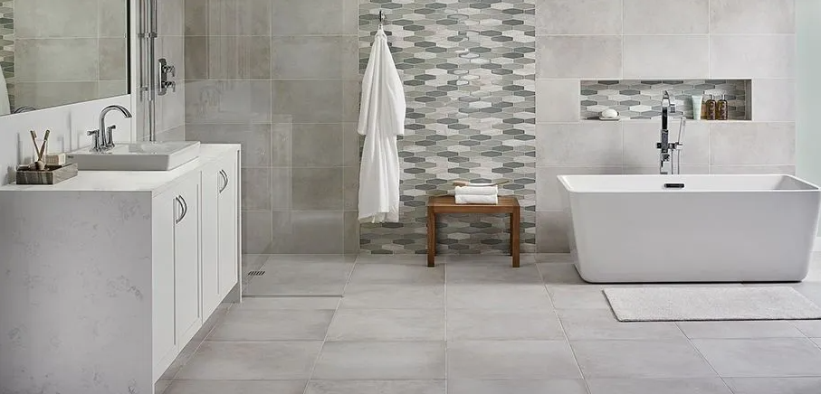A bathroom with a tub , sink , mirror and shower.