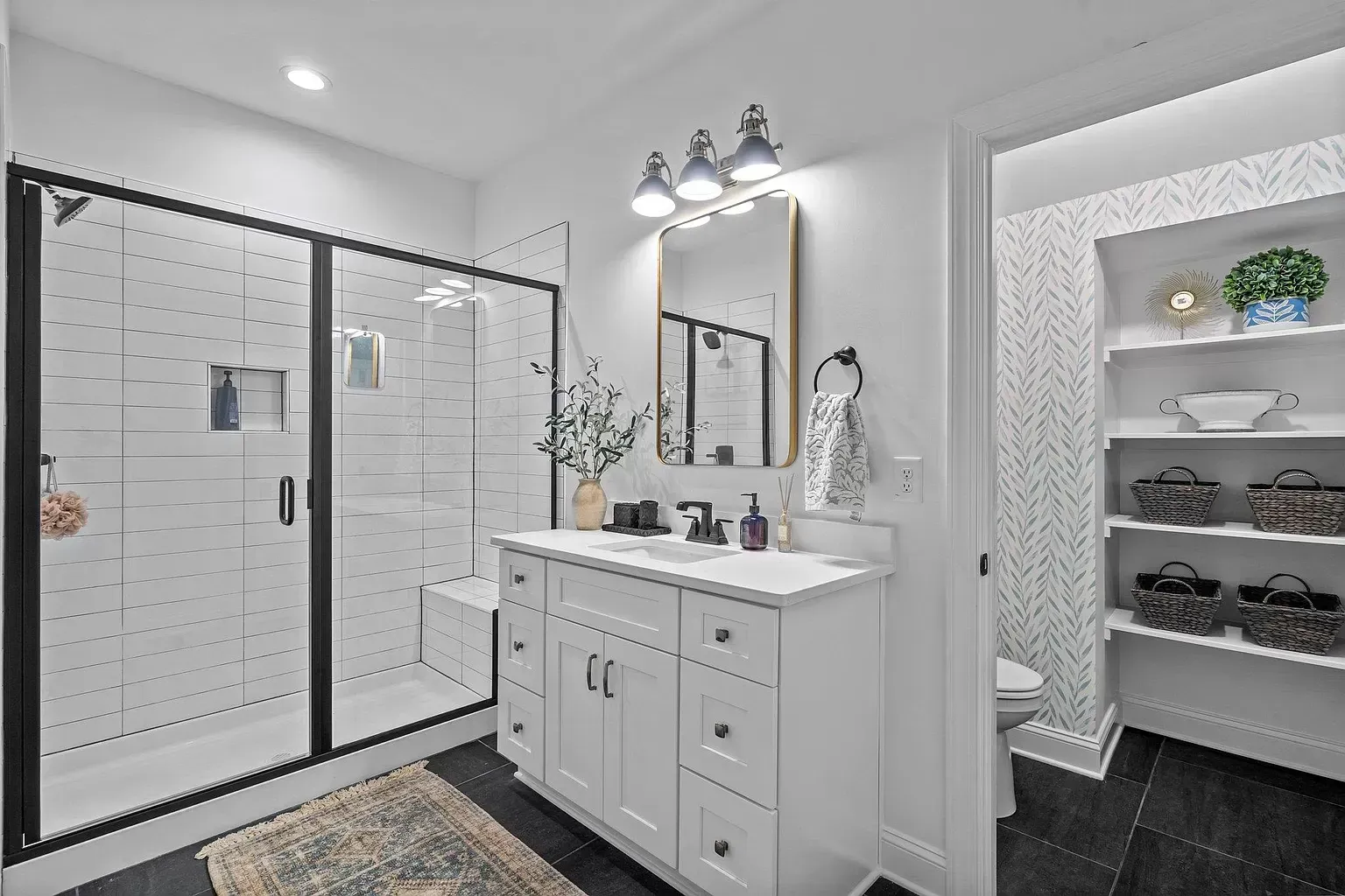 A bathroom with a sink , mirror , and shower.