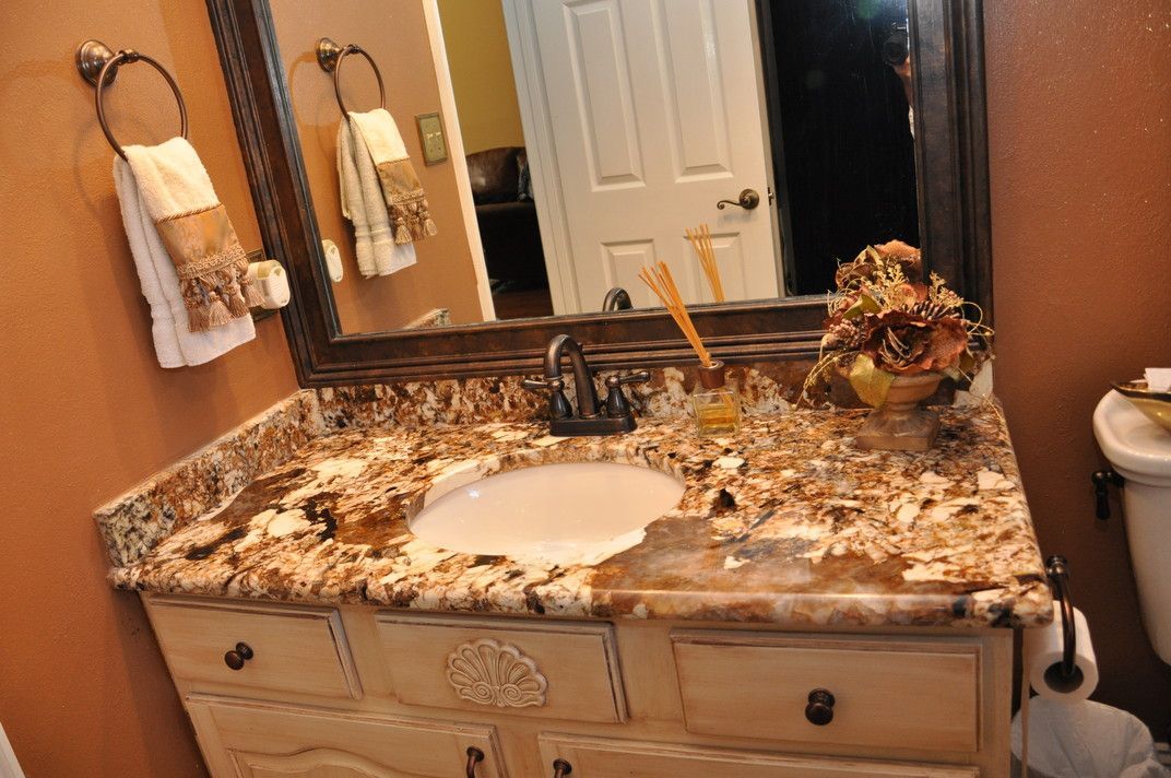A bathroom with a sink , mirror and toilet.