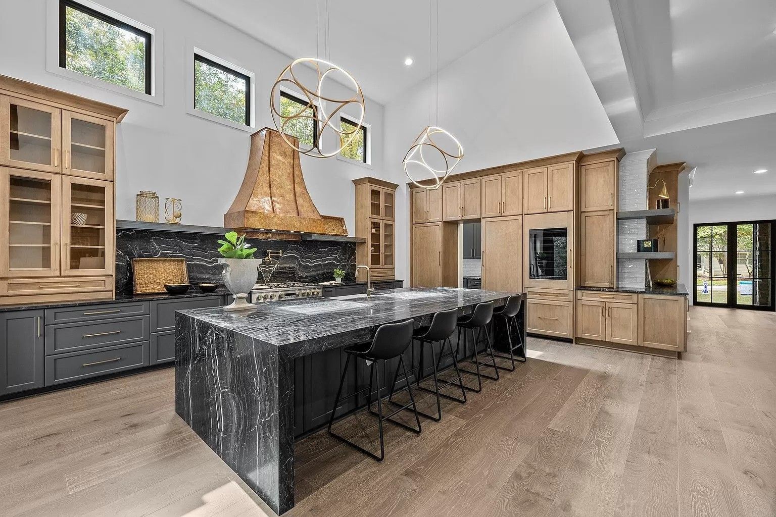 A large kitchen with a large island and stools.