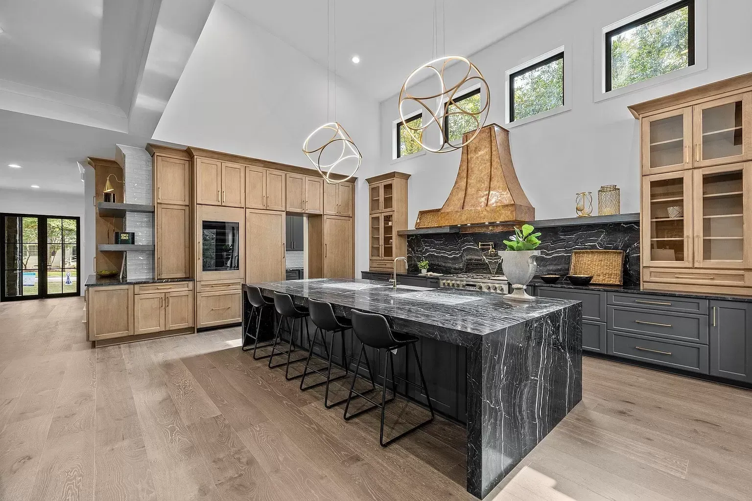 A large kitchen with a large island and lots of cabinets.