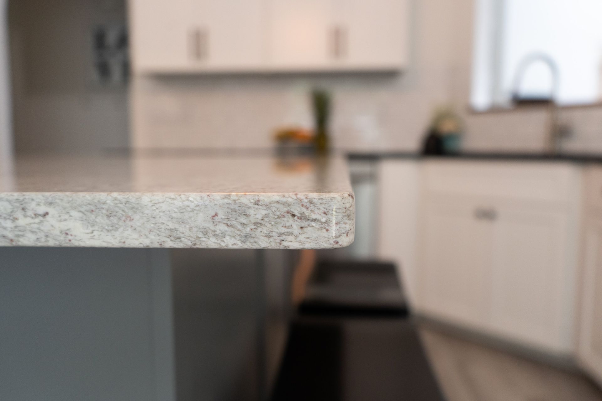 A close up of a granite counter top in a kitchen.