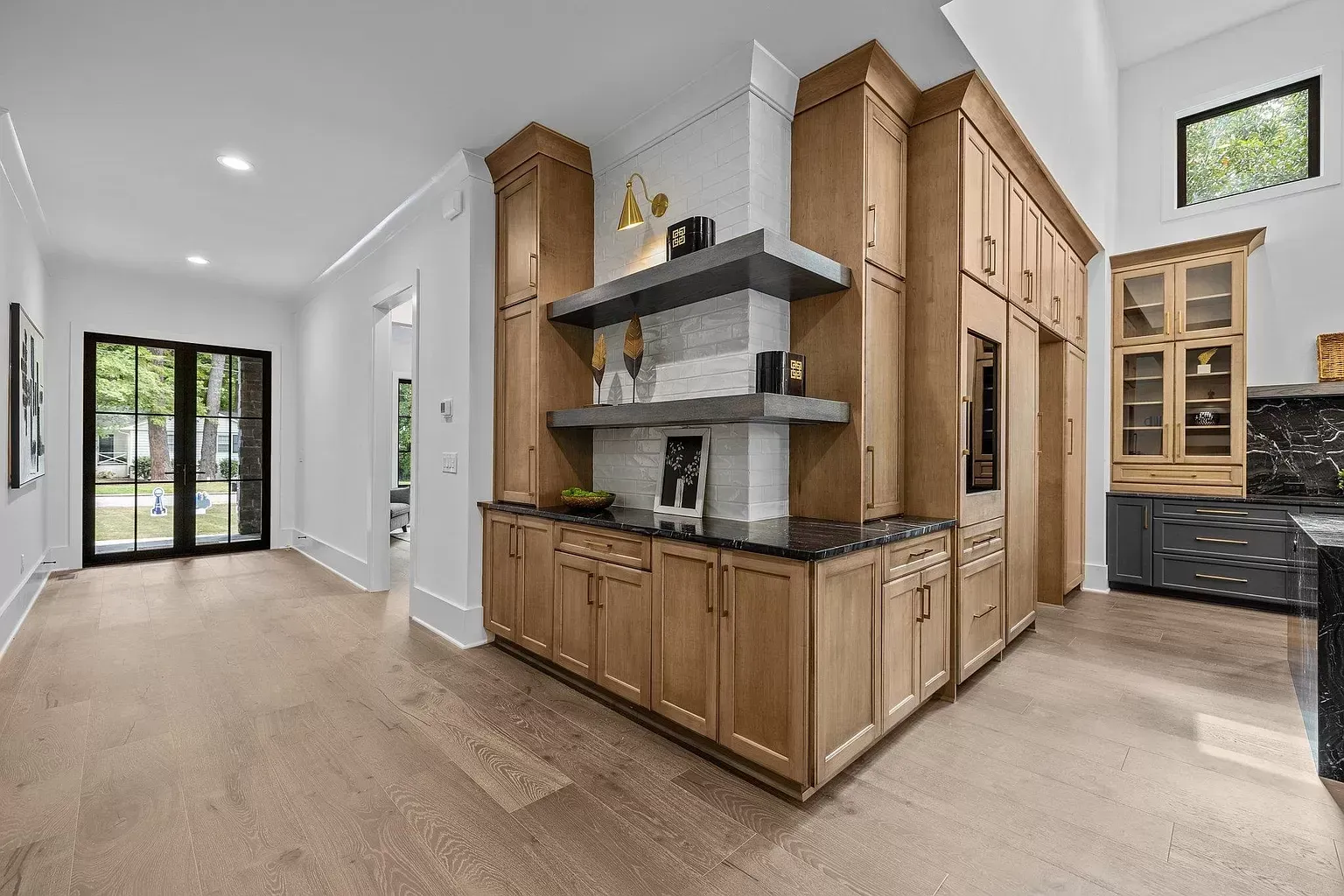 A kitchen with wooden cabinets , granite counter tops , and stainless steel appliances.
