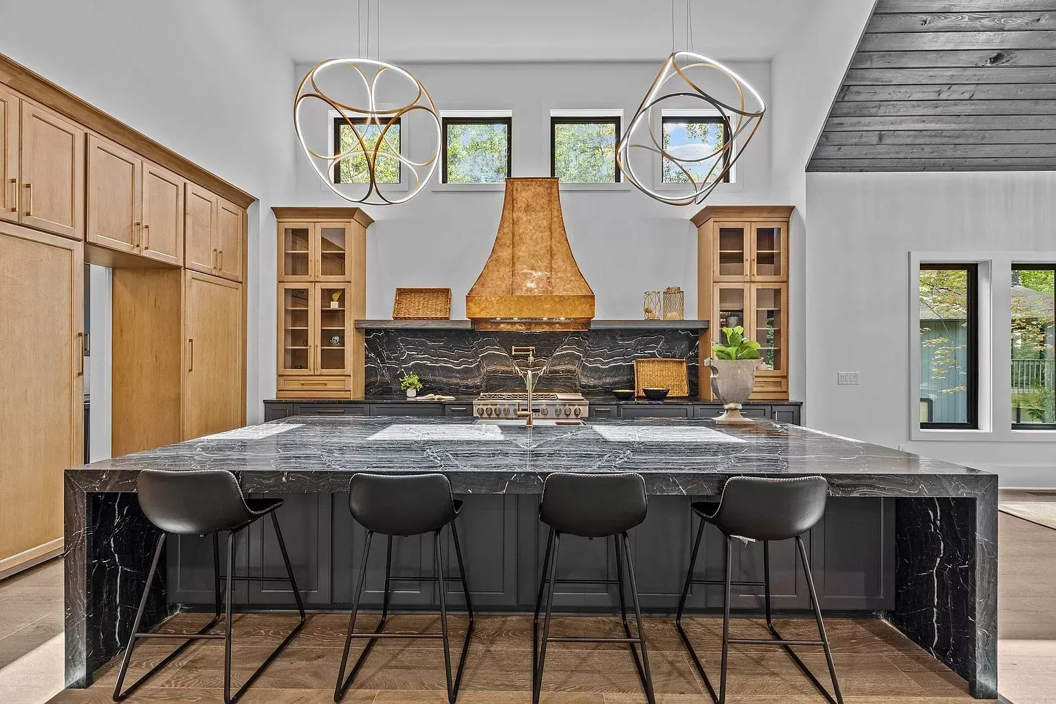 A large kitchen with a large island and stools.