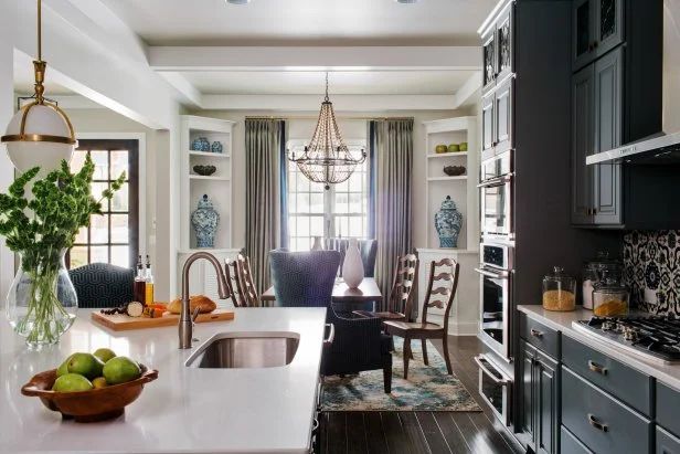 A kitchen with a sink and a bowl of limes on the counter.