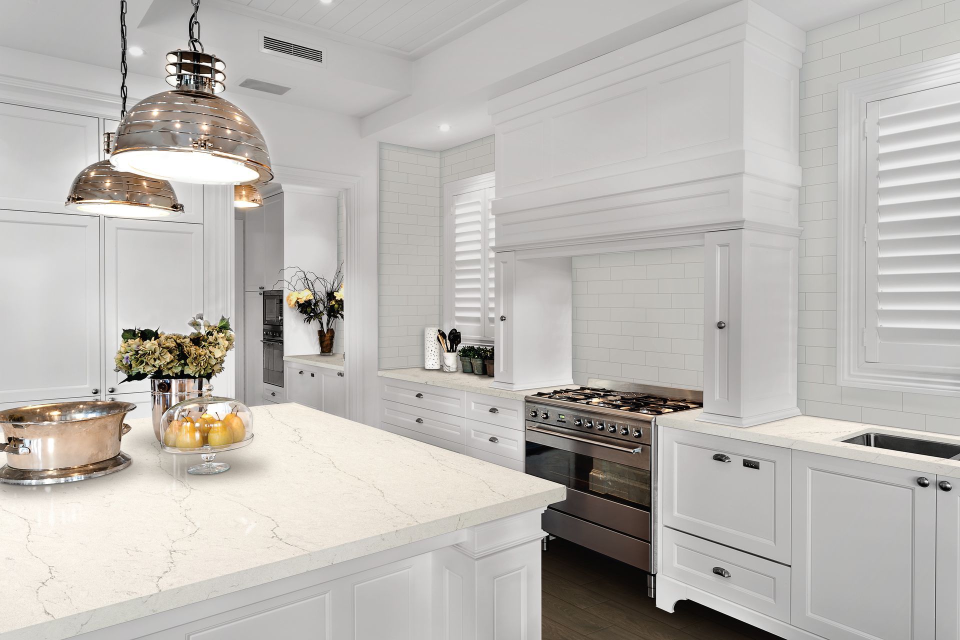 A kitchen with white cabinets and stainless steel appliances