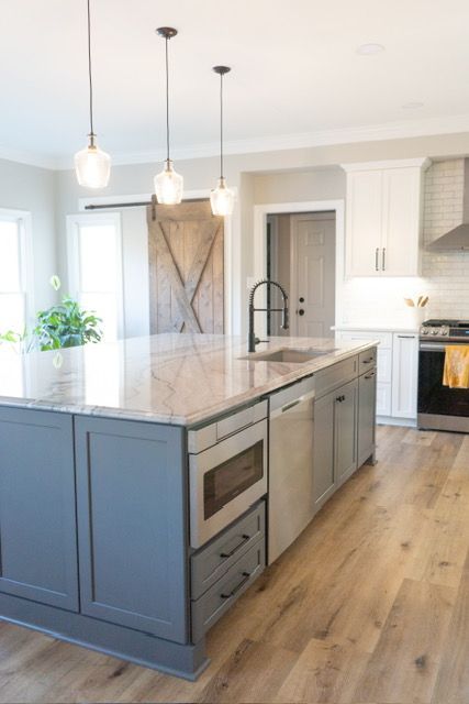 A kitchen with a large island in the middle of the room.