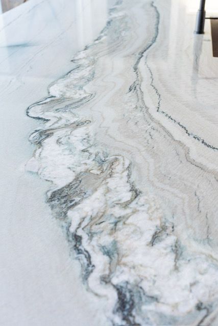 A close up of a marble counter top with a swirl pattern.