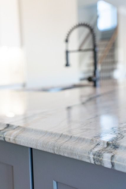 A kitchen counter with a sink and a faucet on it.
