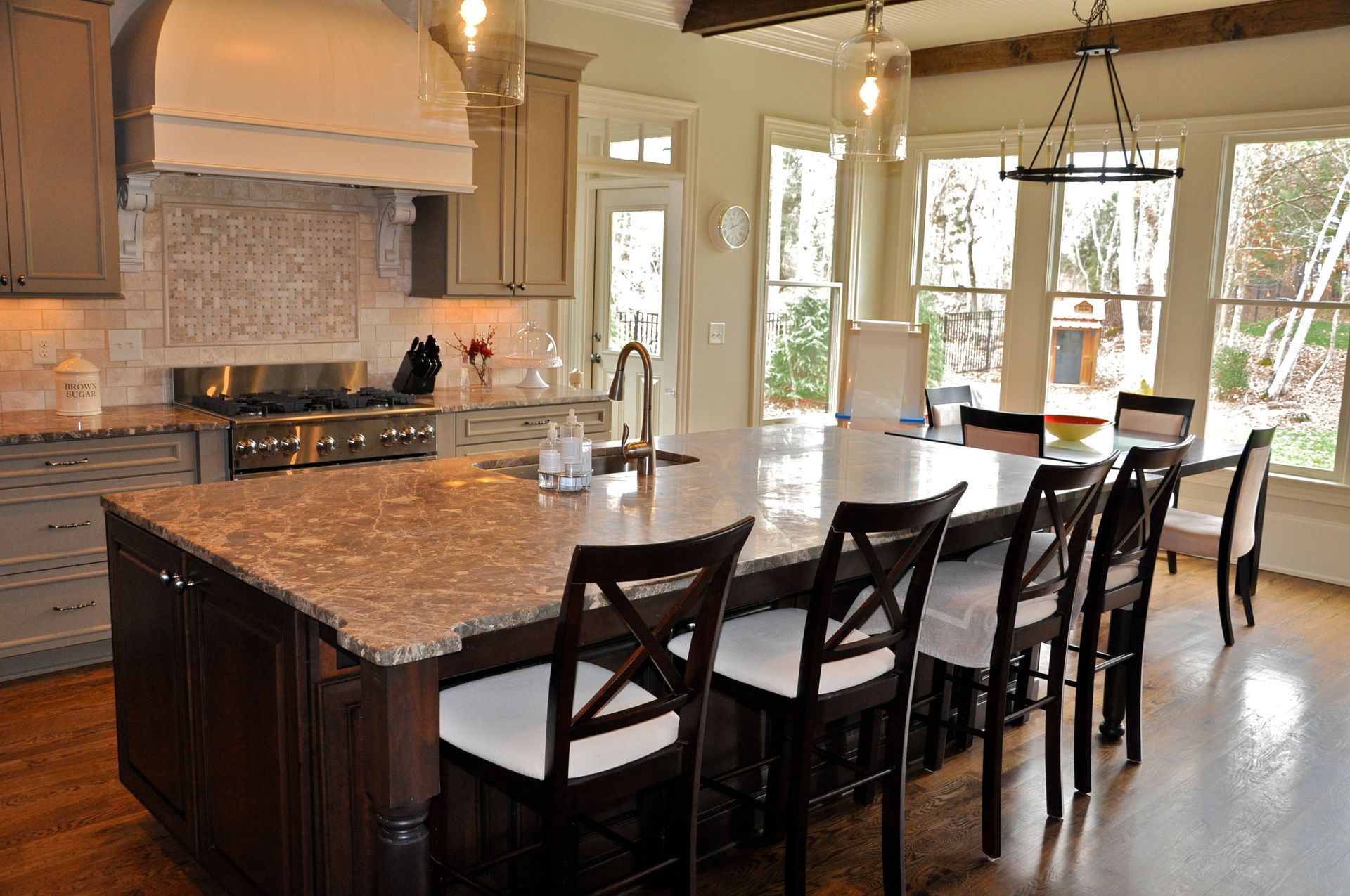 A kitchen with a large island and a dining table