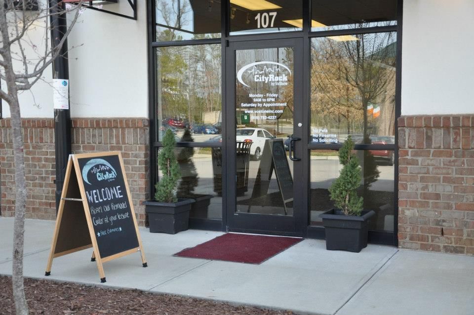 The front door of a building with a welcome sign in front of it.