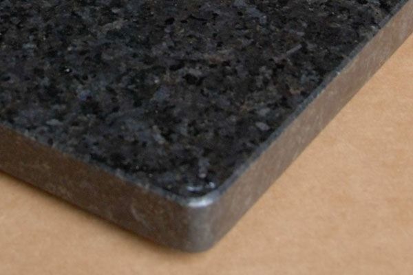 A black granite counter top with a metal edge
