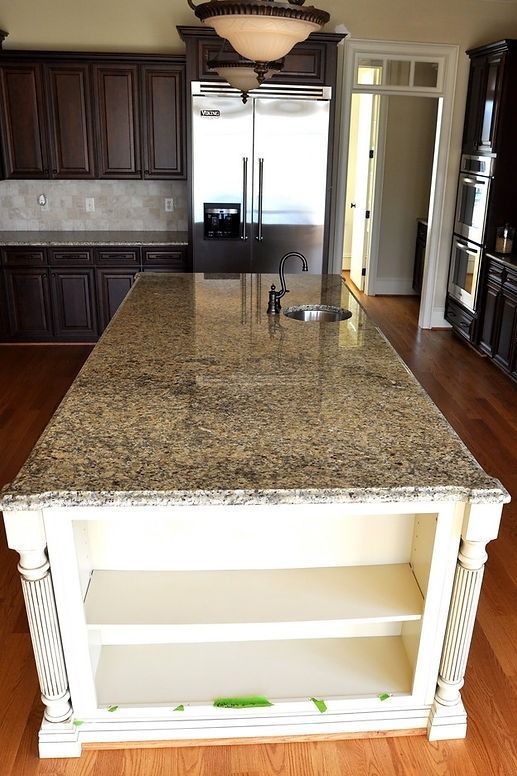 There is a large island in the middle of the kitchen.