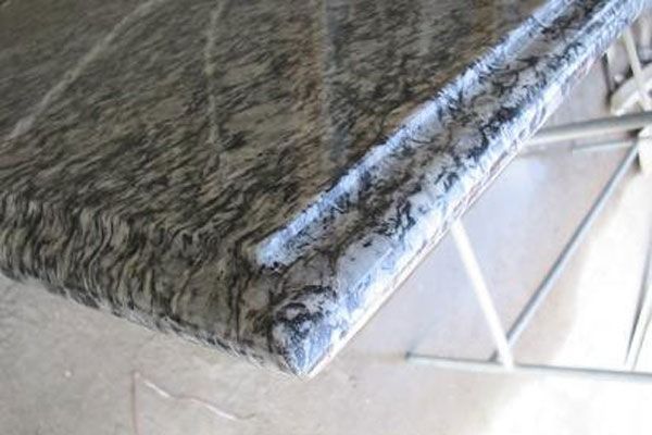 A close up of a marble counter top on a table.