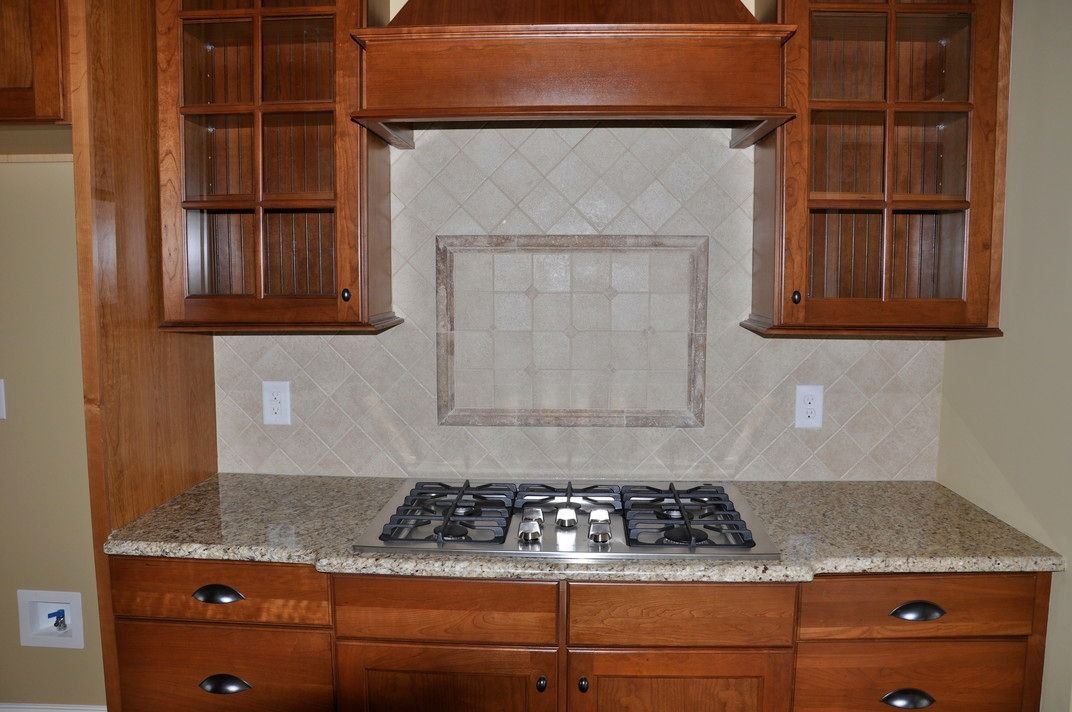 A kitchen with wooden cabinets and a stove top oven