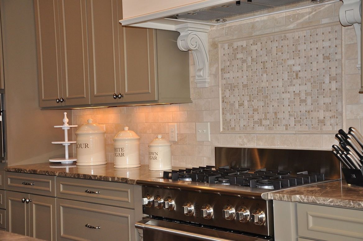 A kitchen with a stove top oven and cabinets